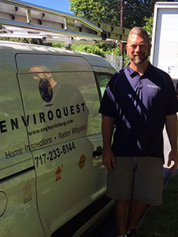 J Staz standing next to Enviroquest van.